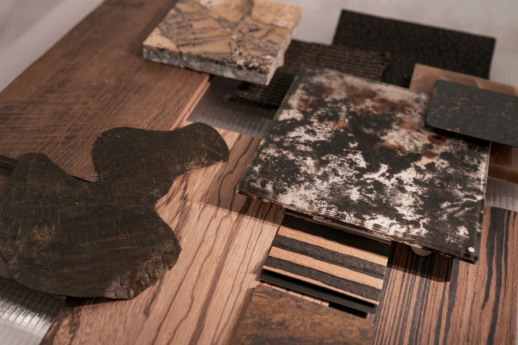 Wood and stone material samples laid out on a table