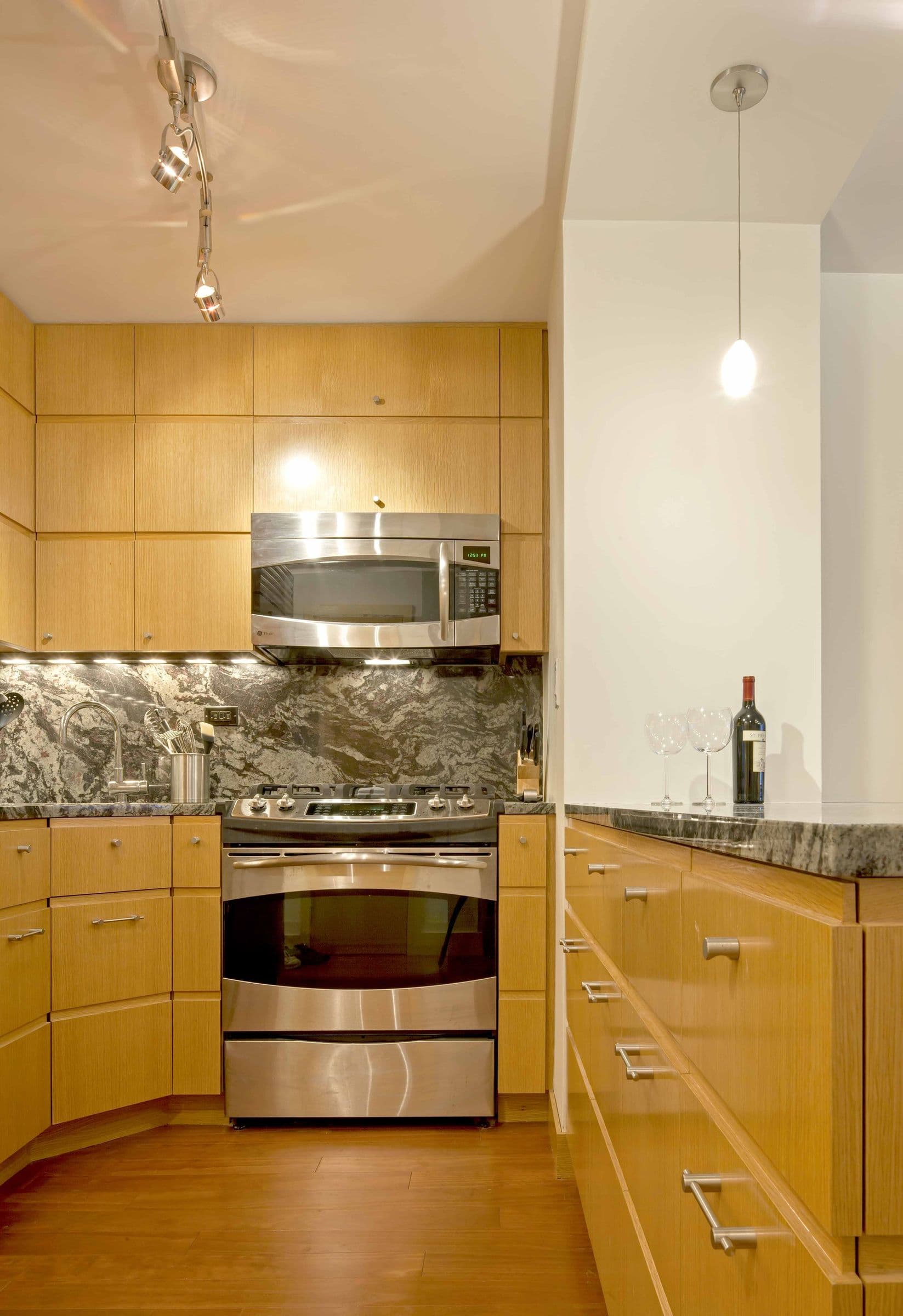 The Baxter Residence kitchen, maple cabinetry with a granite backsplash and stainless range