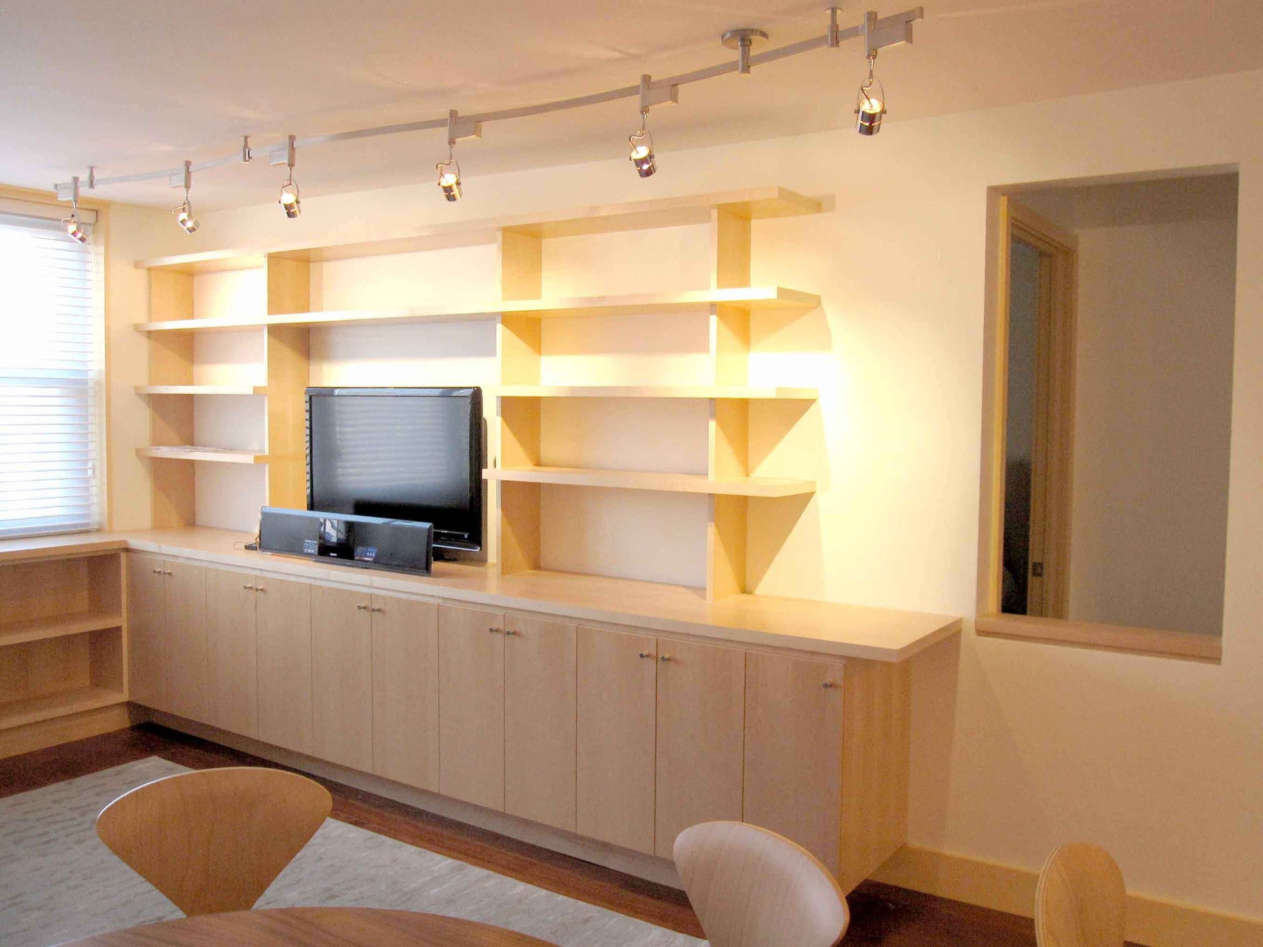 The Baxter Residence living room, lined with maple built-in shelving and cabinetry
