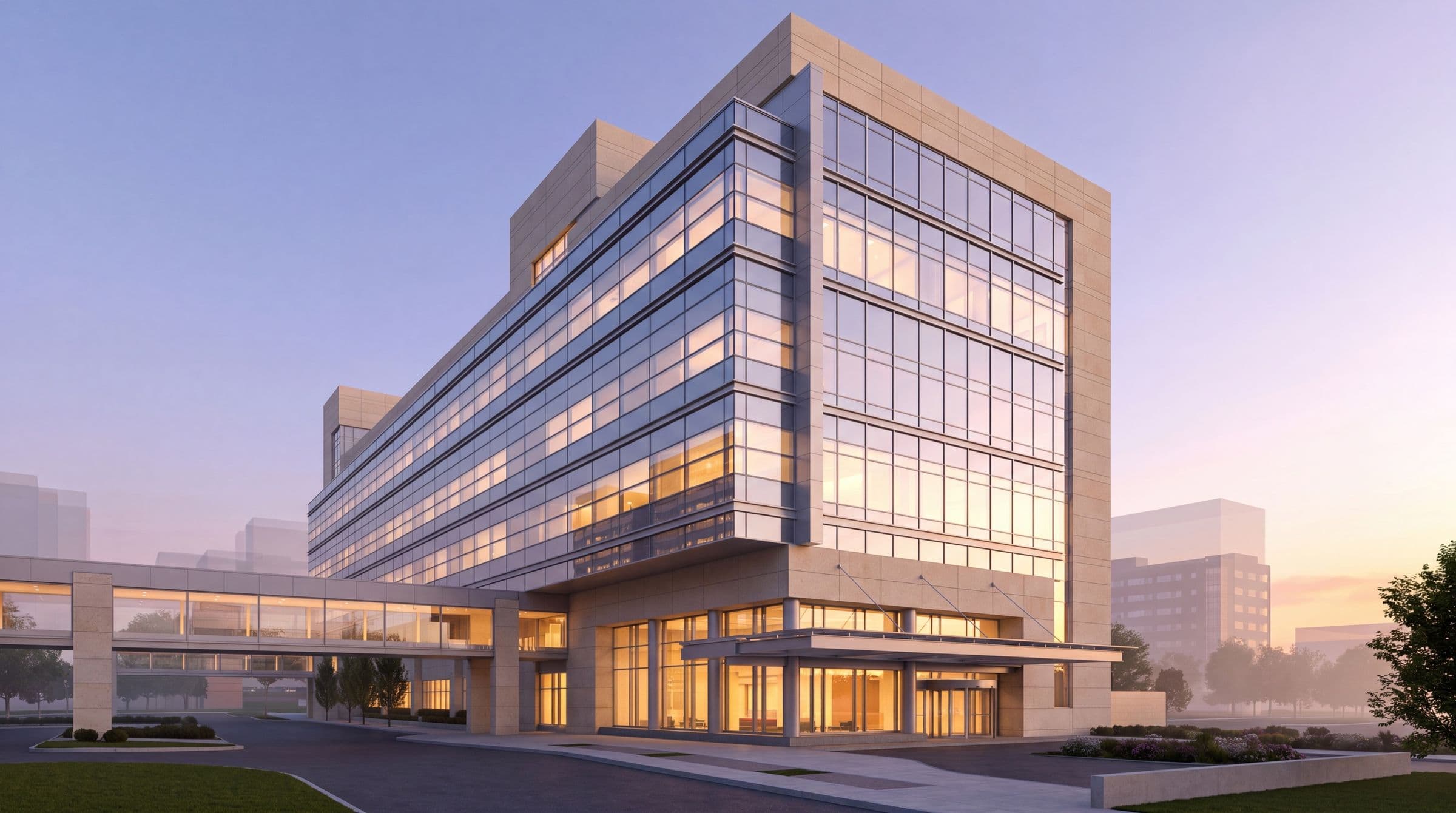 A limestone and glass building by Calderón Architecture, its curtain wall glowing warmly at dusk