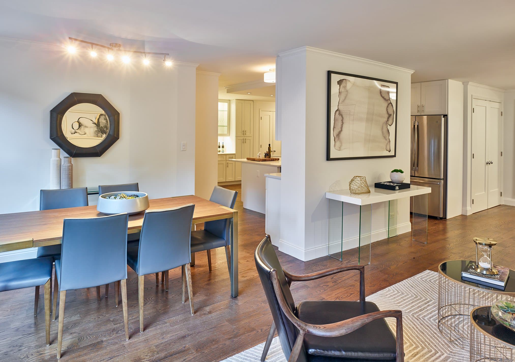 The Greenbaum Residence dining room with a walnut table, looking toward the kitchen