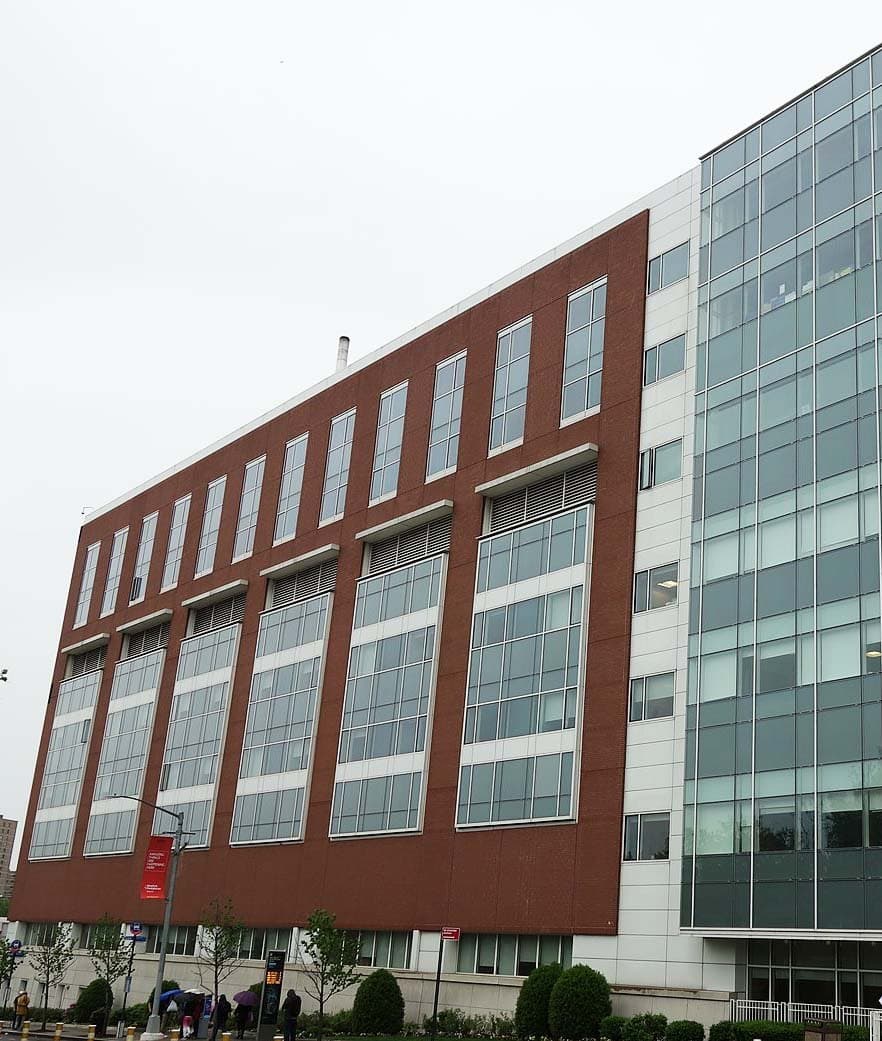 The bed tower facade at NewYork-Presbyterian Queens, brick panels and a glass curtain wall